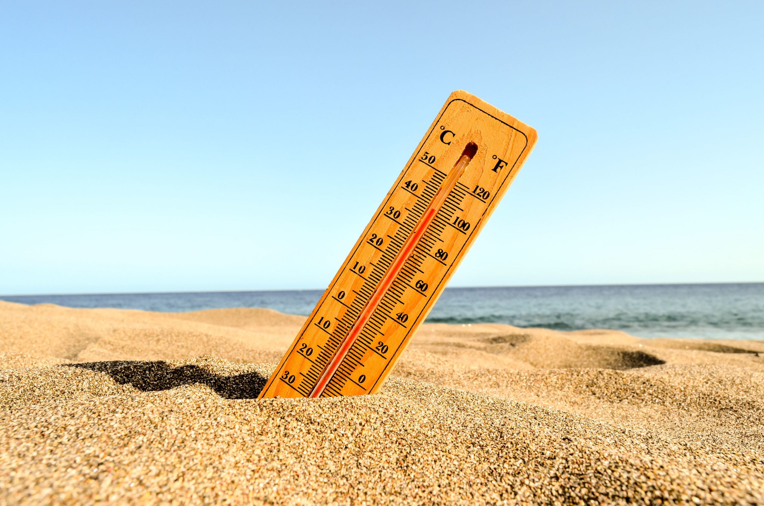 closeup-shot-of-thermometer-in-the-beach-sand-scaled-1.jpg